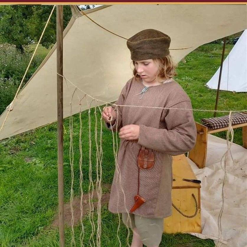 Re-enactor tying cord to make a net
