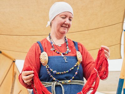 Reenactor lifting dyed wool