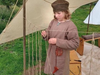 Reenactor tying twine